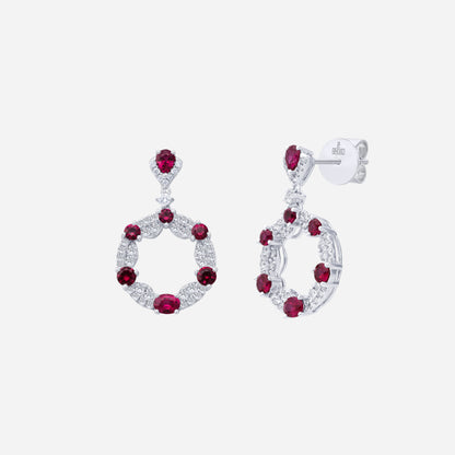 Ruby and diamond earrings in 18K white gold, featuring a circular drop design with alternating rubies and diamonds.