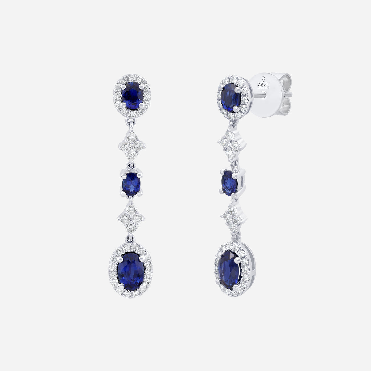 Blue sapphire and diamond earrings in 18K white gold with cascading design and delicate diamond accents.