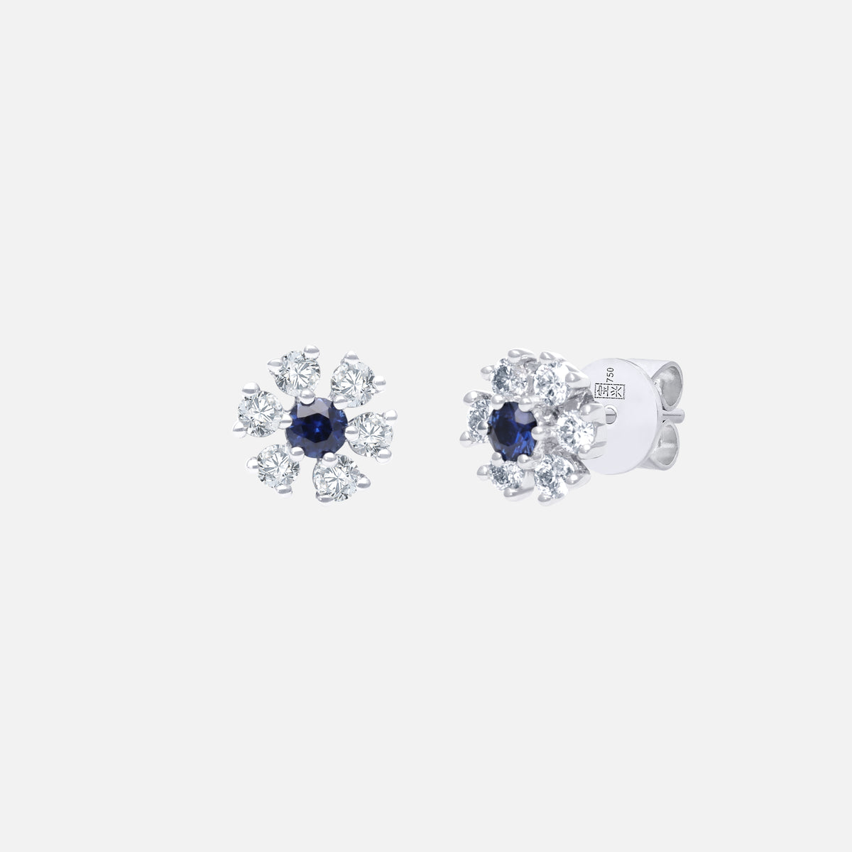 Blue sapphire stud earrings with diamond accents in 18K white gold, featuring a floral design for elegant sparkle.