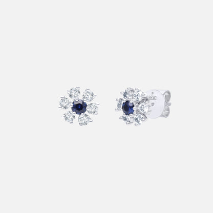 Blue sapphire stud earrings with diamond accents in 18K white gold, featuring a floral design for elegant sparkle.